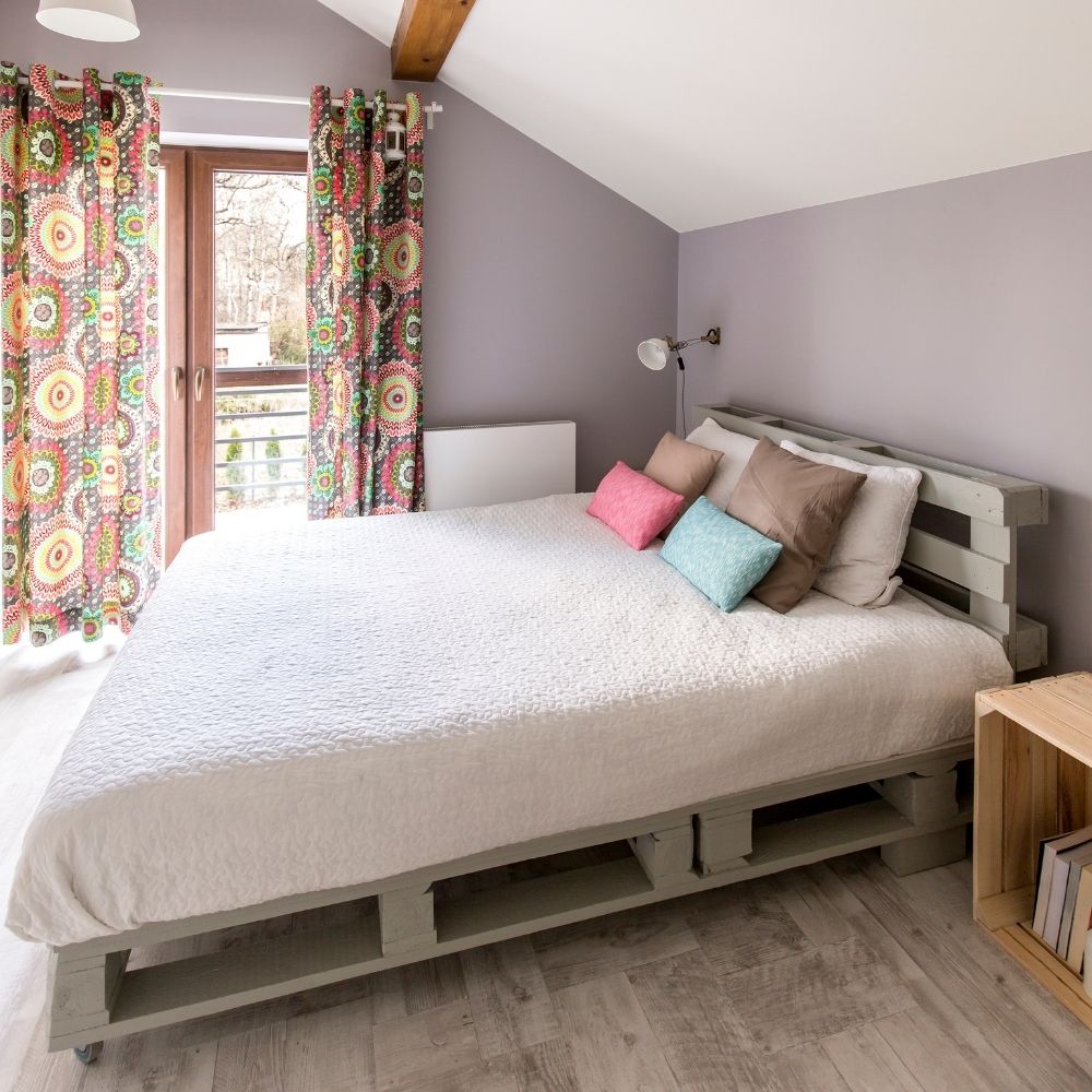 Turnover cleaning service making a bed in a Dewey, OK Airbnb